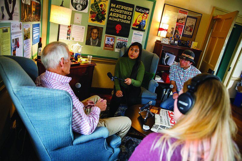 Three Washington College students collect oral history by recording a man speaking with them.